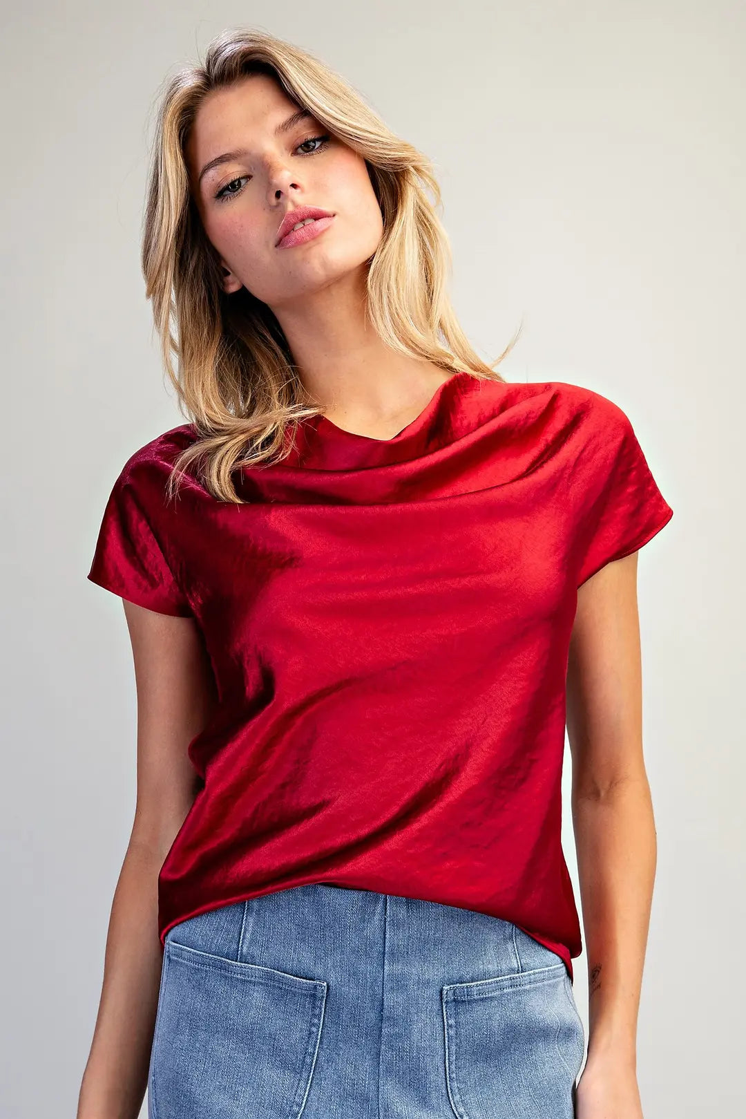 Women's red satin short sleeve top featuring a softly draped cowl neckline and relaxed silhouette.