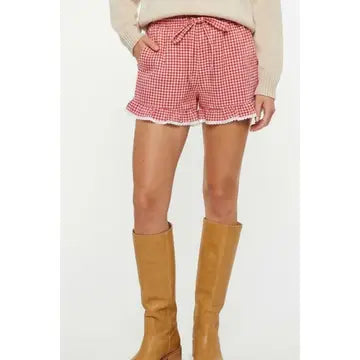 Women’s red and cream gingham shorts featuring a ruffled hem, delicate cream lace trim and self-tie waist detail.