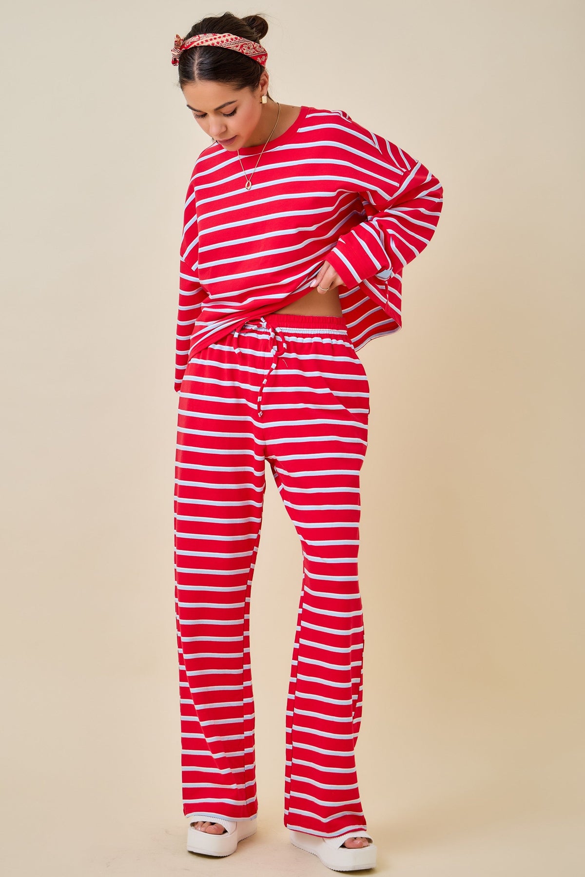 Women’s cherry red and light blue striped full-length pants with elastic drawstring waistband and relaxed leg fit.