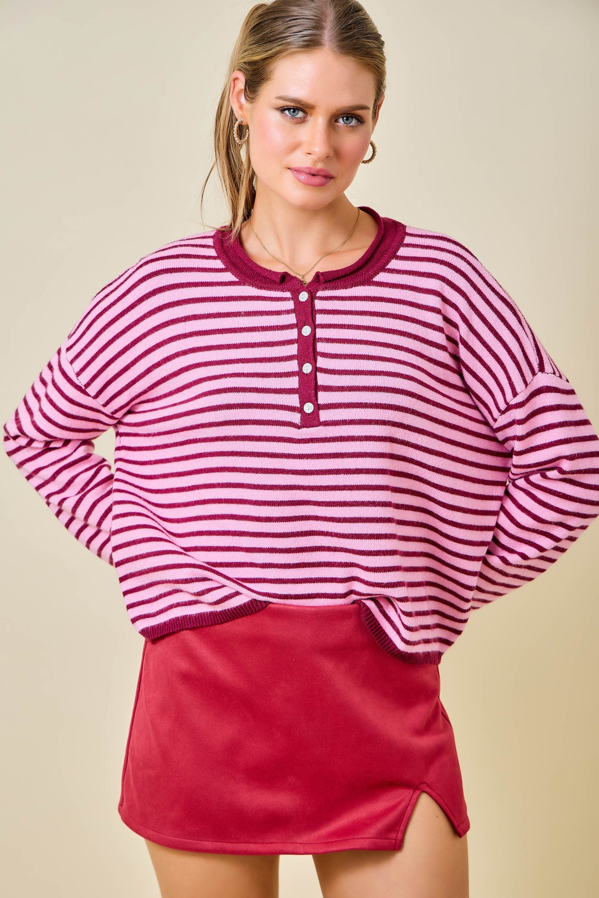 Women's pink and berry striped long sleeve Henley sweater with button neckline and relaxed fit