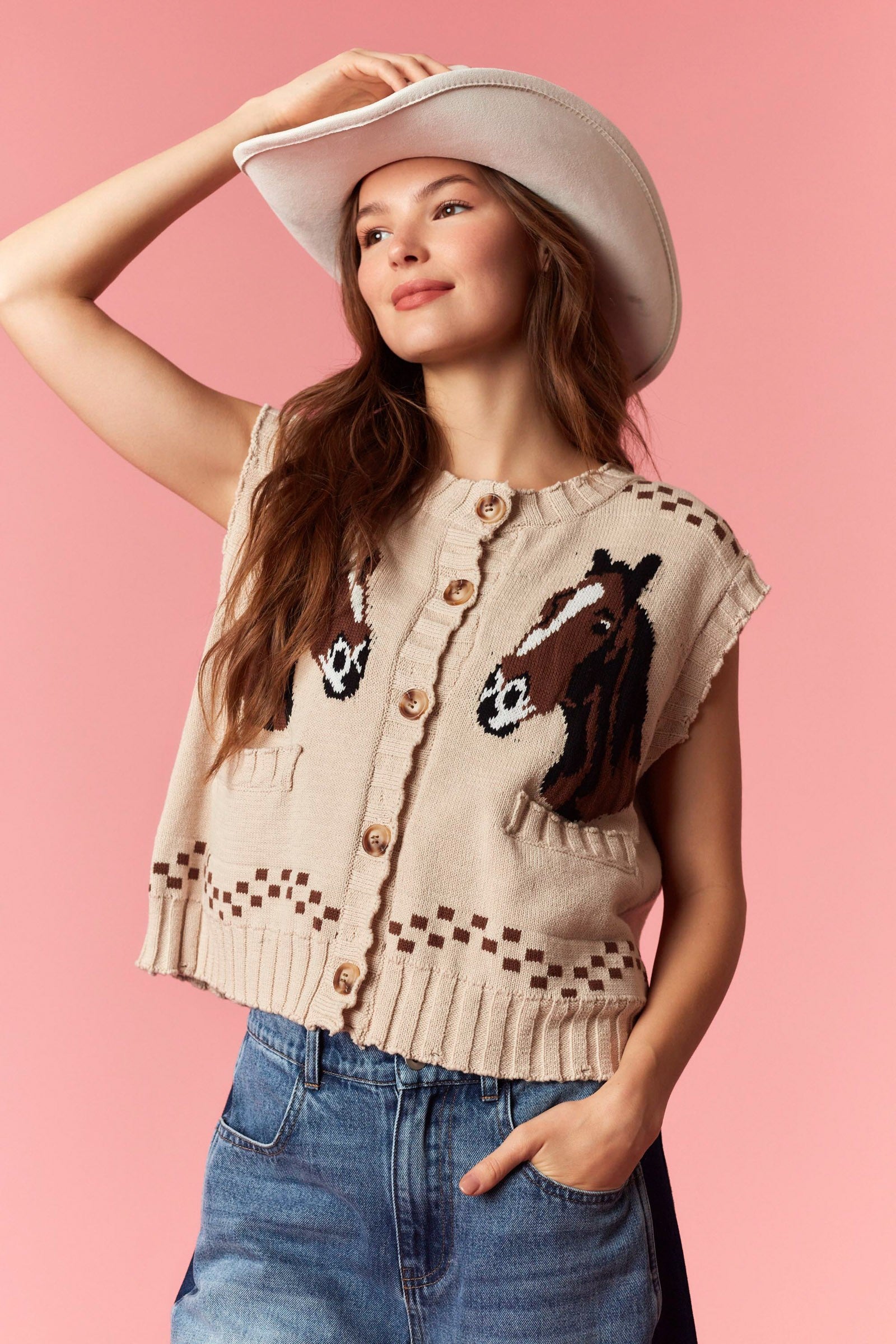Knitted vest with horse and geometric patterns, button-up front, and front pockets, paired with blue jeans