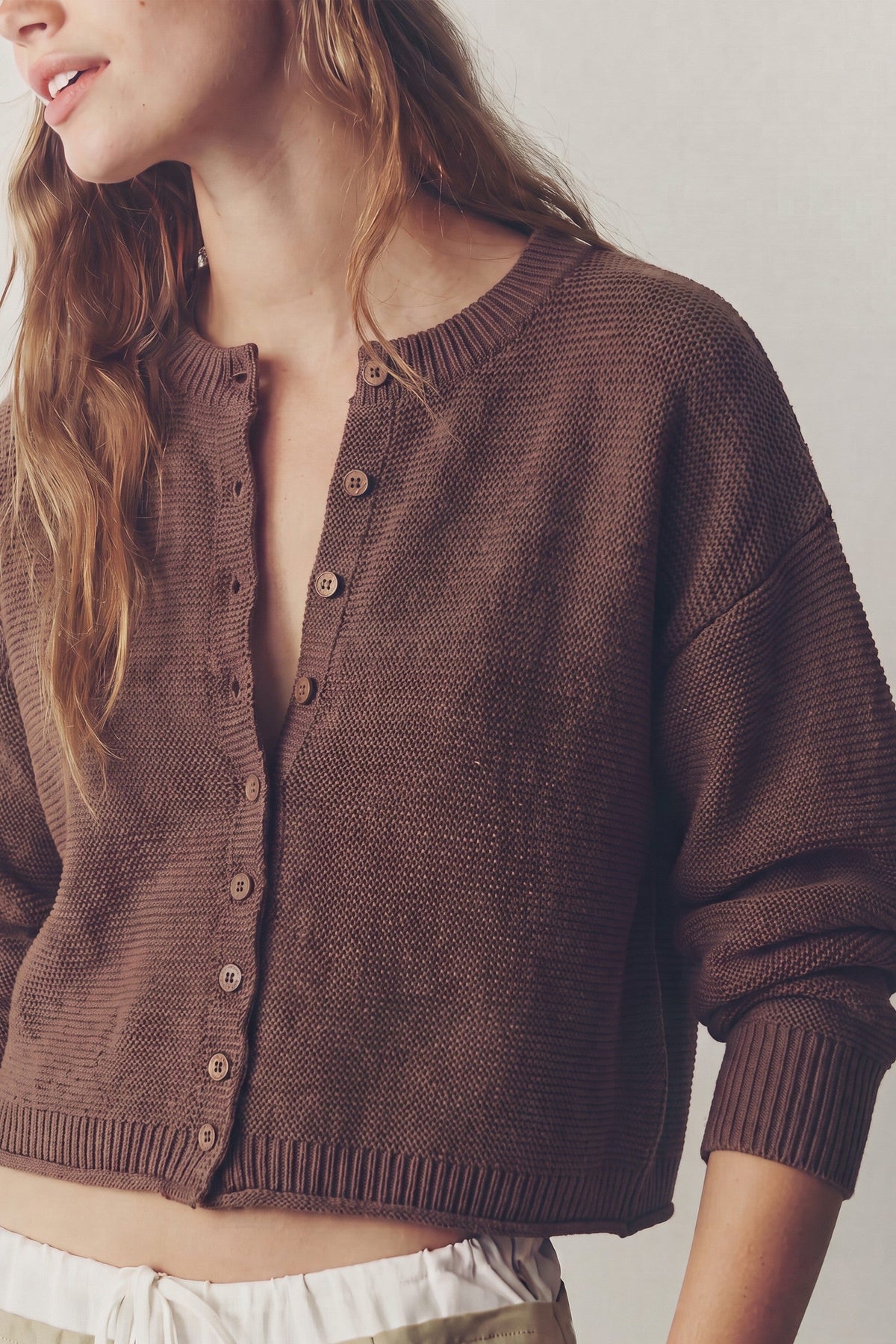 Women's chocolate brown textured knit cardigan with button-front closure, long sleeves, dropped shoulders and ribbed trim.