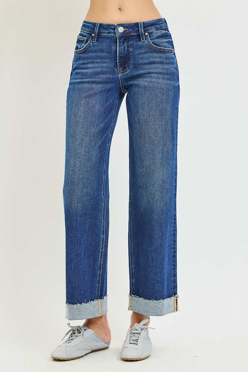 Women’s mid-rise straight leg denim jeans with oversized releasable cuff and stretch fabric.