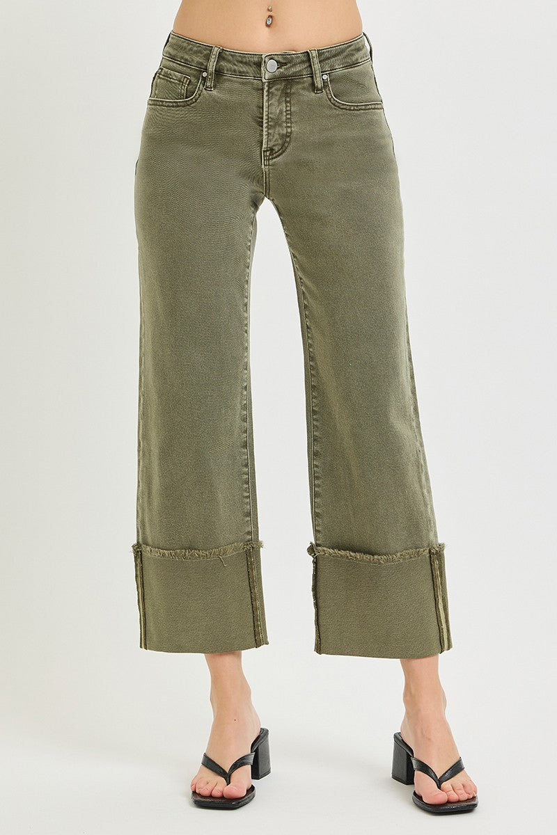 Olive green wide leg jeans with cuffed hems, mid-rise fit, five pockets, distressed details, made of stretch denim, styled with heels