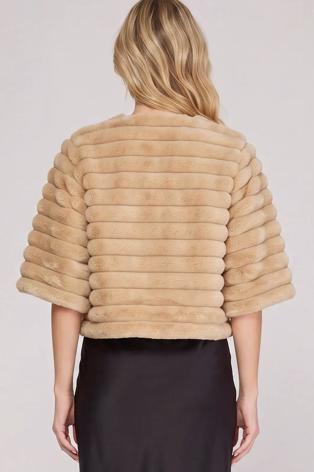 Women's champagne beige cropped faux fur jacket featuring plush horizontal ribbed detailing, a rounded neckline, three-quarter sleeves, and an elegant soft faux fur finish.