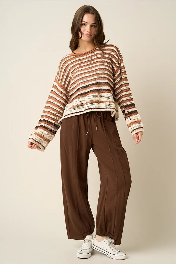 Lightweight crochet knit sweater with multicolor brown, cream, and black stripes, relaxed fit, long sleeves, perfect for fall layering