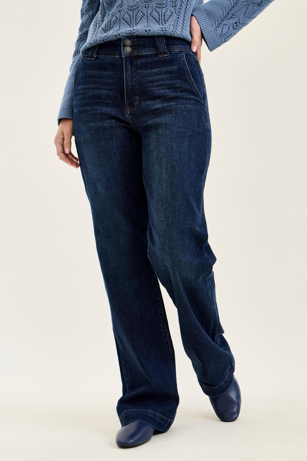 Dark wash high-rise wide leg denim trousers with classic five-pocket styling, belt loops, and full-length fit, perfect for casual or dressy wear.