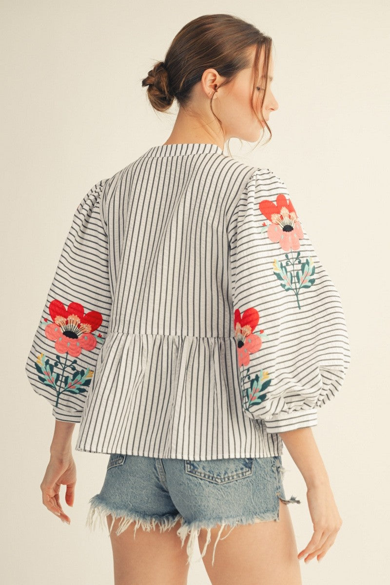 womens embroidered puff sleeve blouse with vertical stripes and peplum fit
