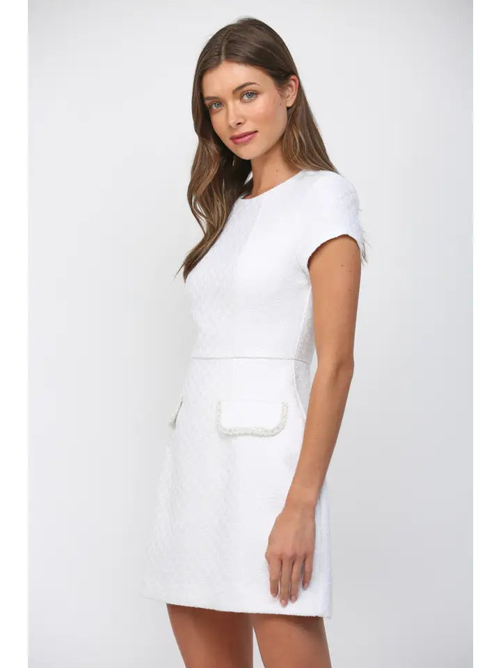 Chic white mini dress with decorative pocket details