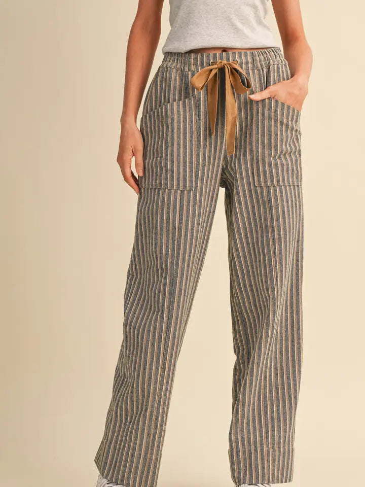 Women’s striped high-rise wide leg pants featuring a covered elastic waistband, contrast drawstring and front and back patch pockets.