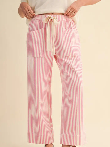 Pink and white striped pants with a drawstring on a beige background