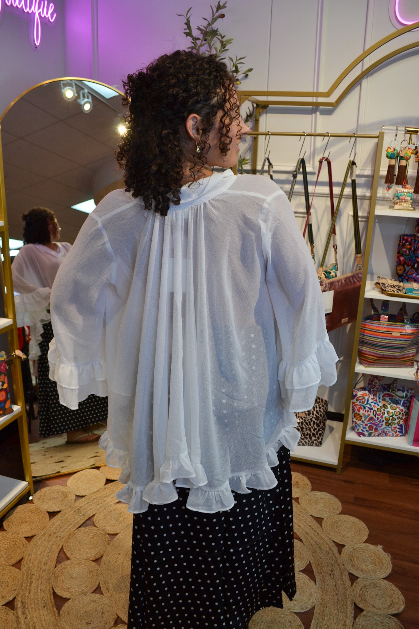 Elegant white chiffon blouse with a neck tie, layered ruffle bell sleeves, and flowy silhouette for women’s fashion.