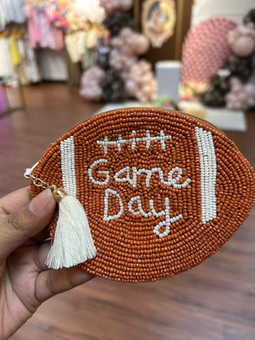 Football shaped pouch with beaded game day written out 