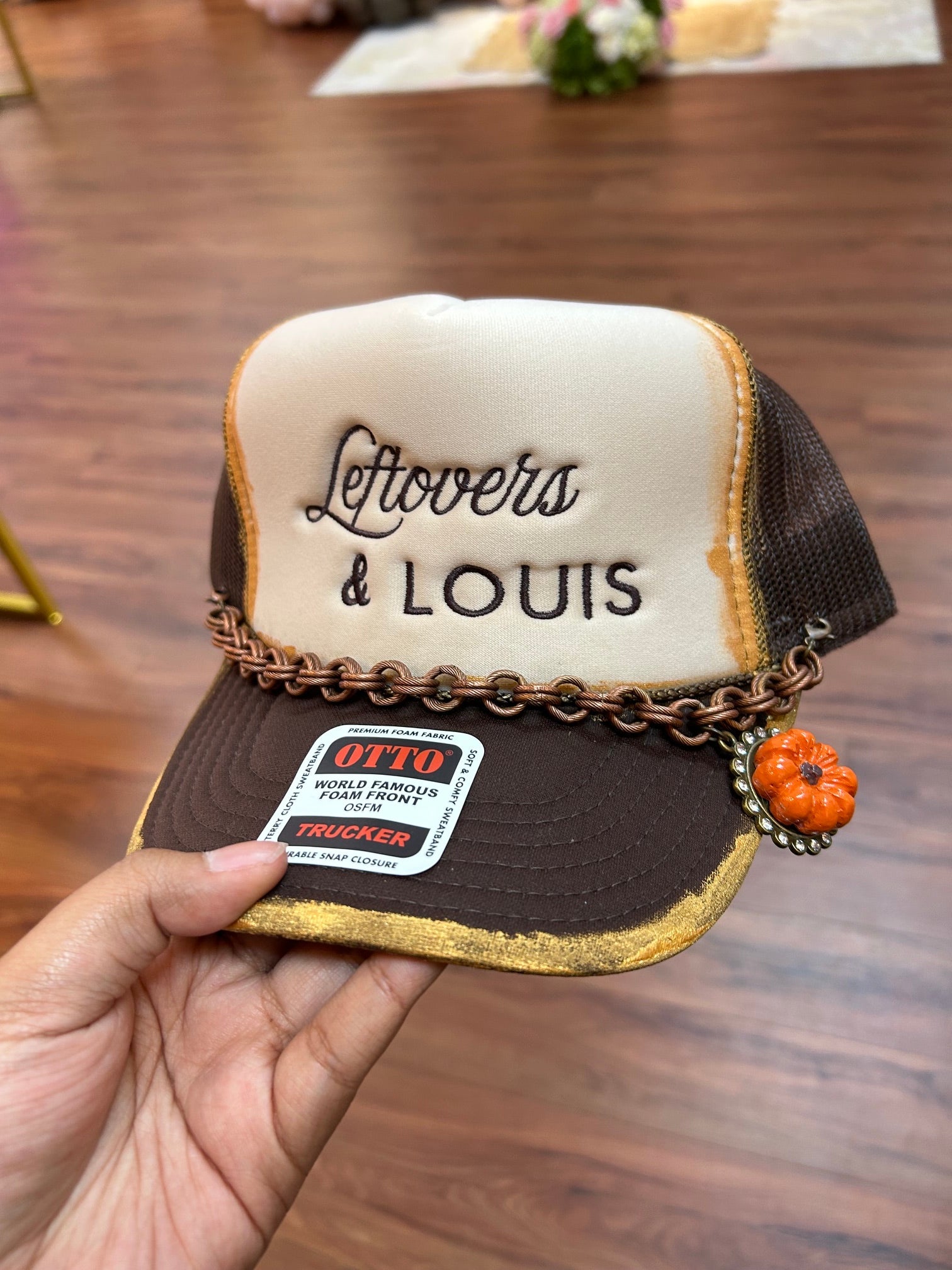 leftovers and Louis trucker hat with a pumpkin charm 