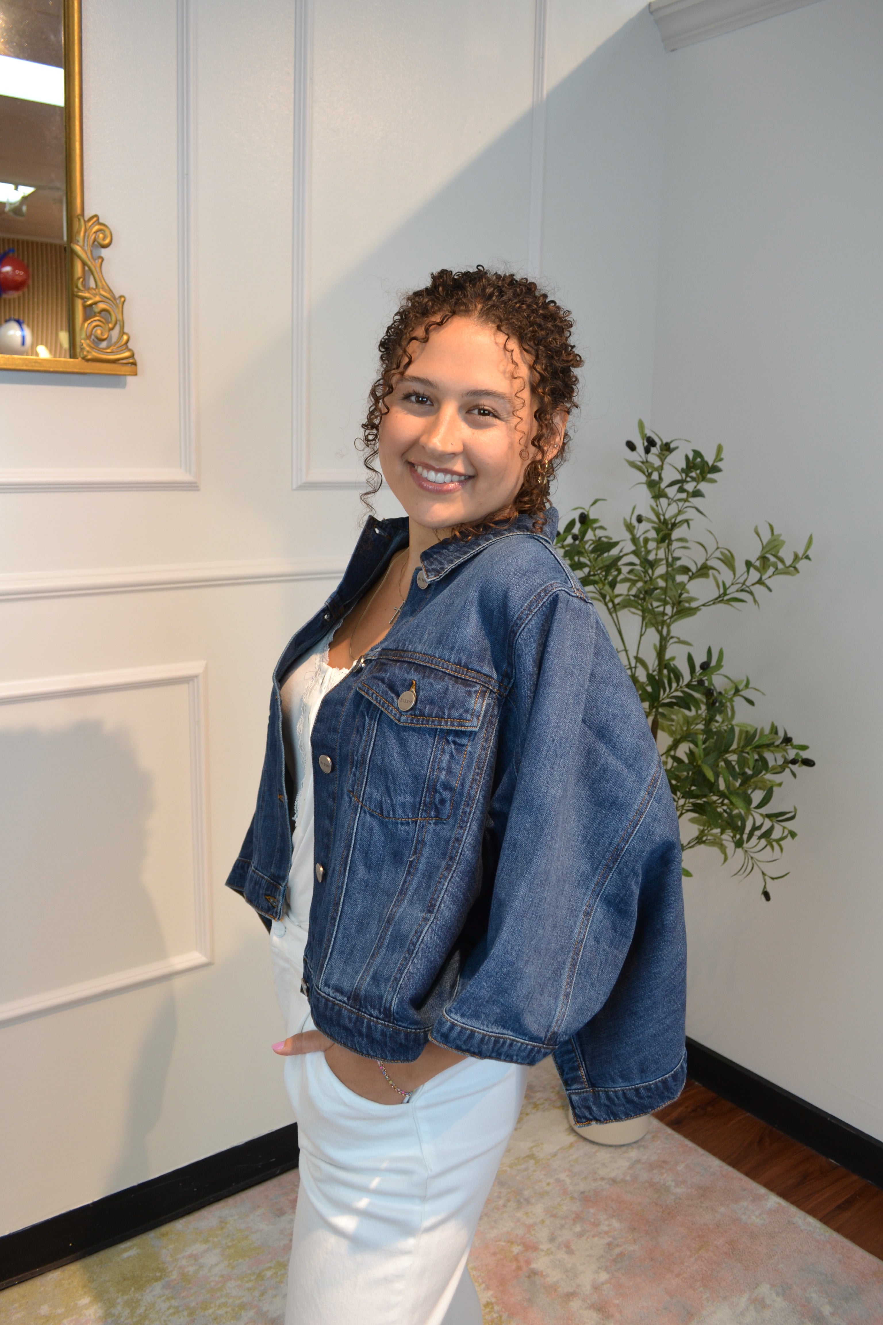 Fashion-forward cropped denim jacket with oversized fit and classic dark wash finish.