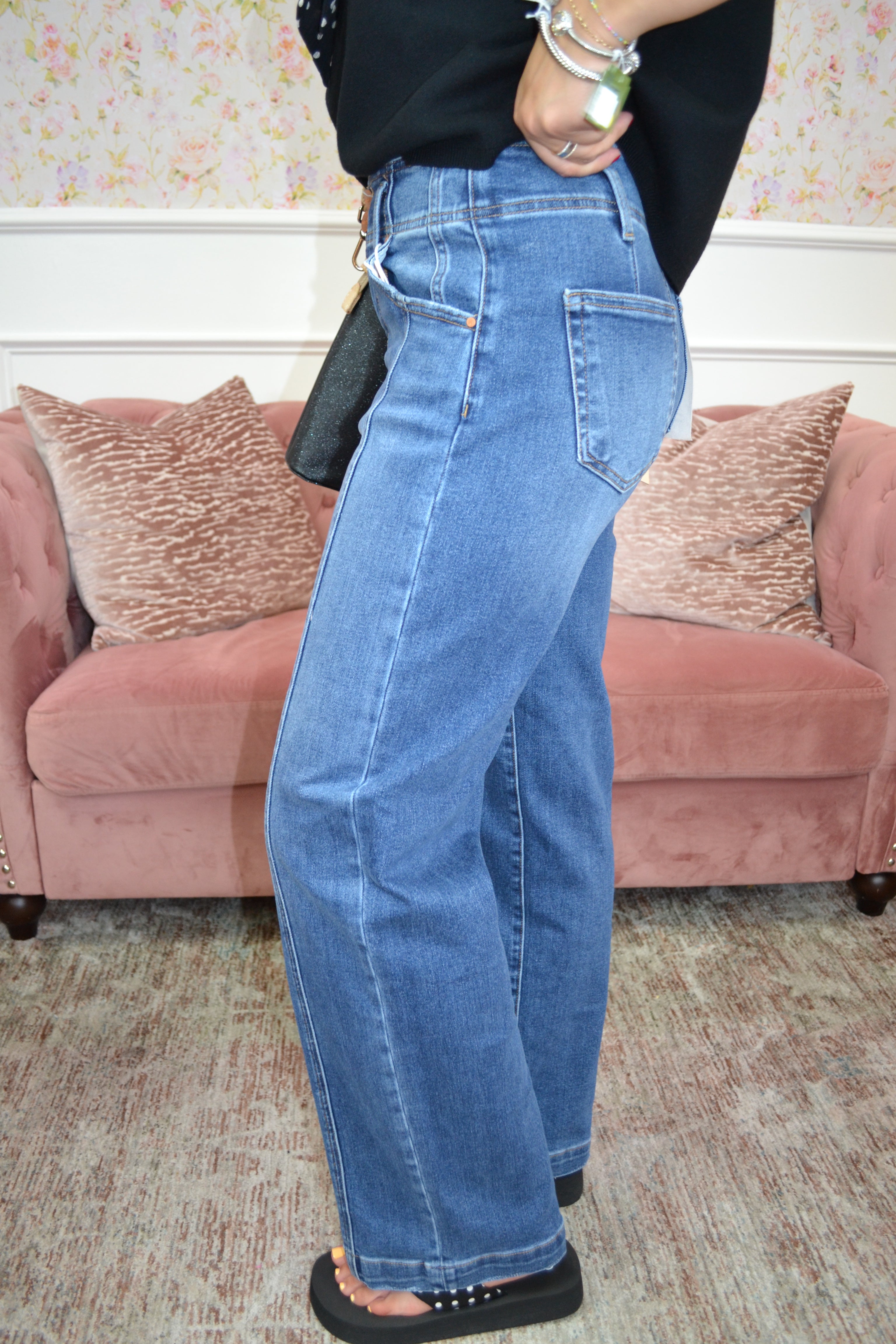 Risen high-waisted denim jeans with double-button waistband and full-length legs.