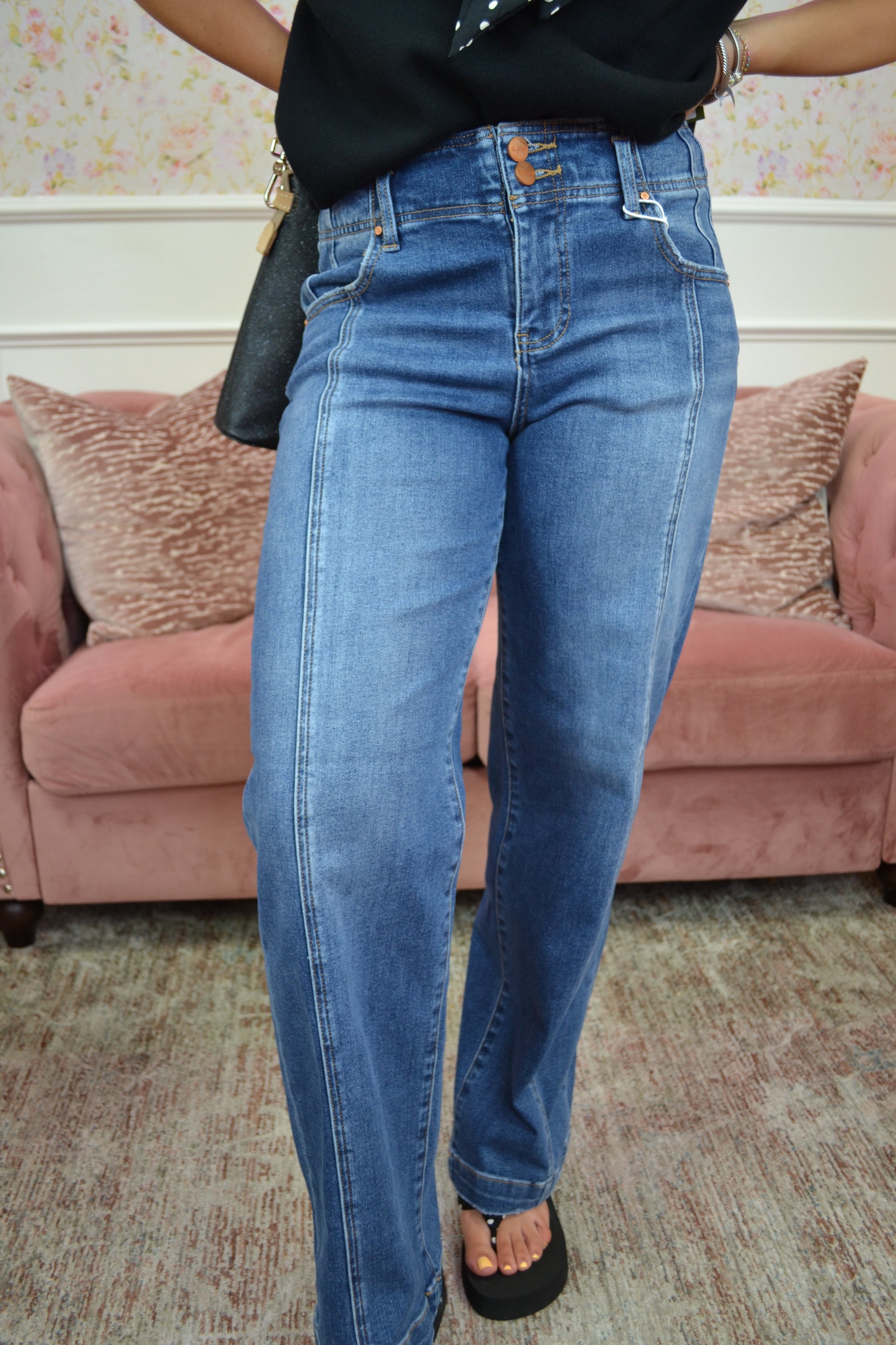 Classic medium wash high-rise straight-leg jeans featuring a flattering double-button waistband, stretch denim, and a timeless silhouette perfect for everyday wear.
