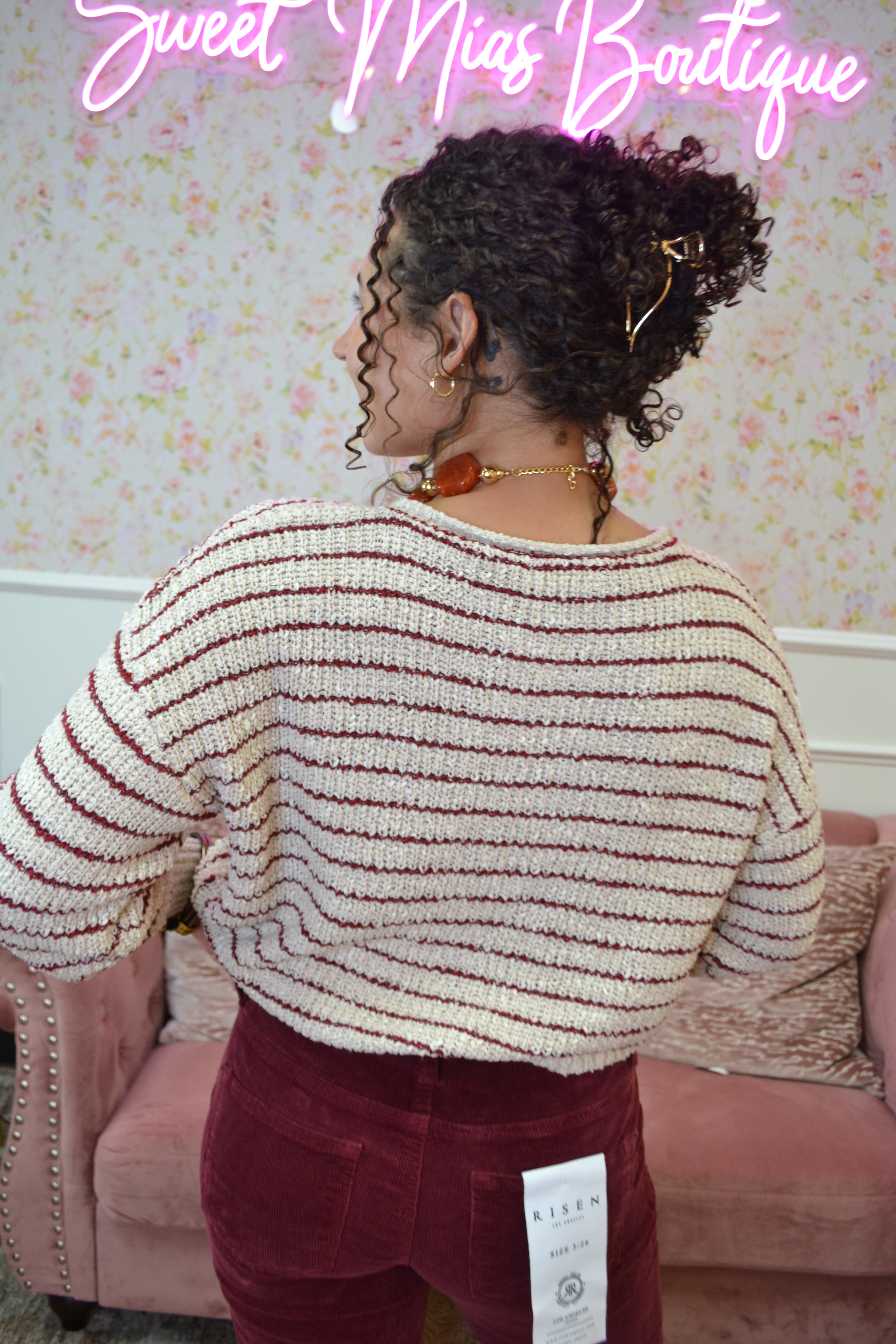 Back view of a lightweight Burgandy and ivory striped cardigan with a relaxed fit and long sleeves.