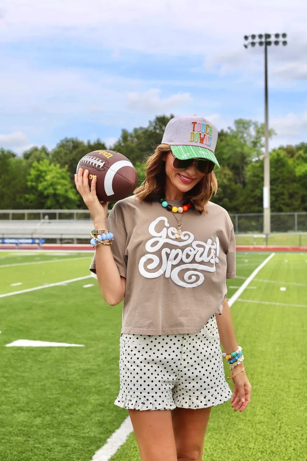 Women’s mocha cropped T-shirt featuring a bold Go Sports graphic, short sleeves and lightweight 100% cotton construction.