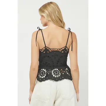 Woman wearing a black lace tank top on a white background