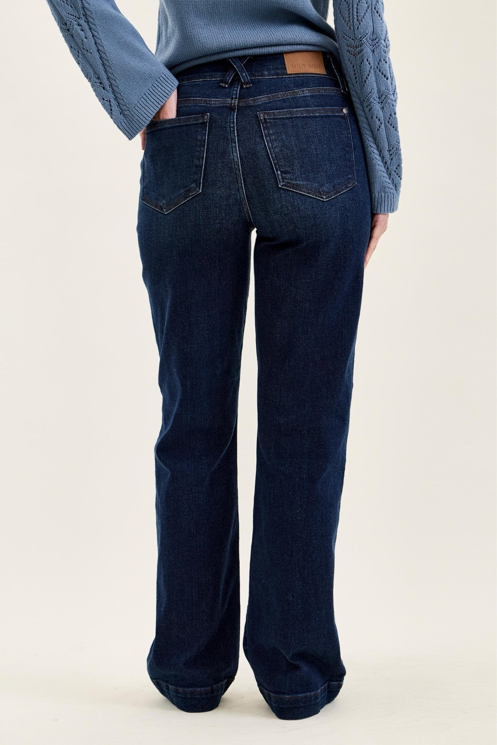 Dark blue high-rise wide leg denim trousers with classic five-pocket styling, made from durable cotton denim fabric, full-length fit