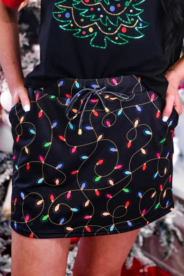 Close-up of Jess Lea Christmas Lights Skort showing the Christmas lights design and drawstring waistband.