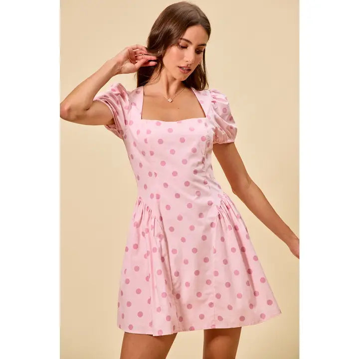 Pink sugar polka dot mini dress with puff sleeves, square neckline, and fit-and-flare silhouette in soft pink with darker pink polka dots, perfect for feminine boutique style.