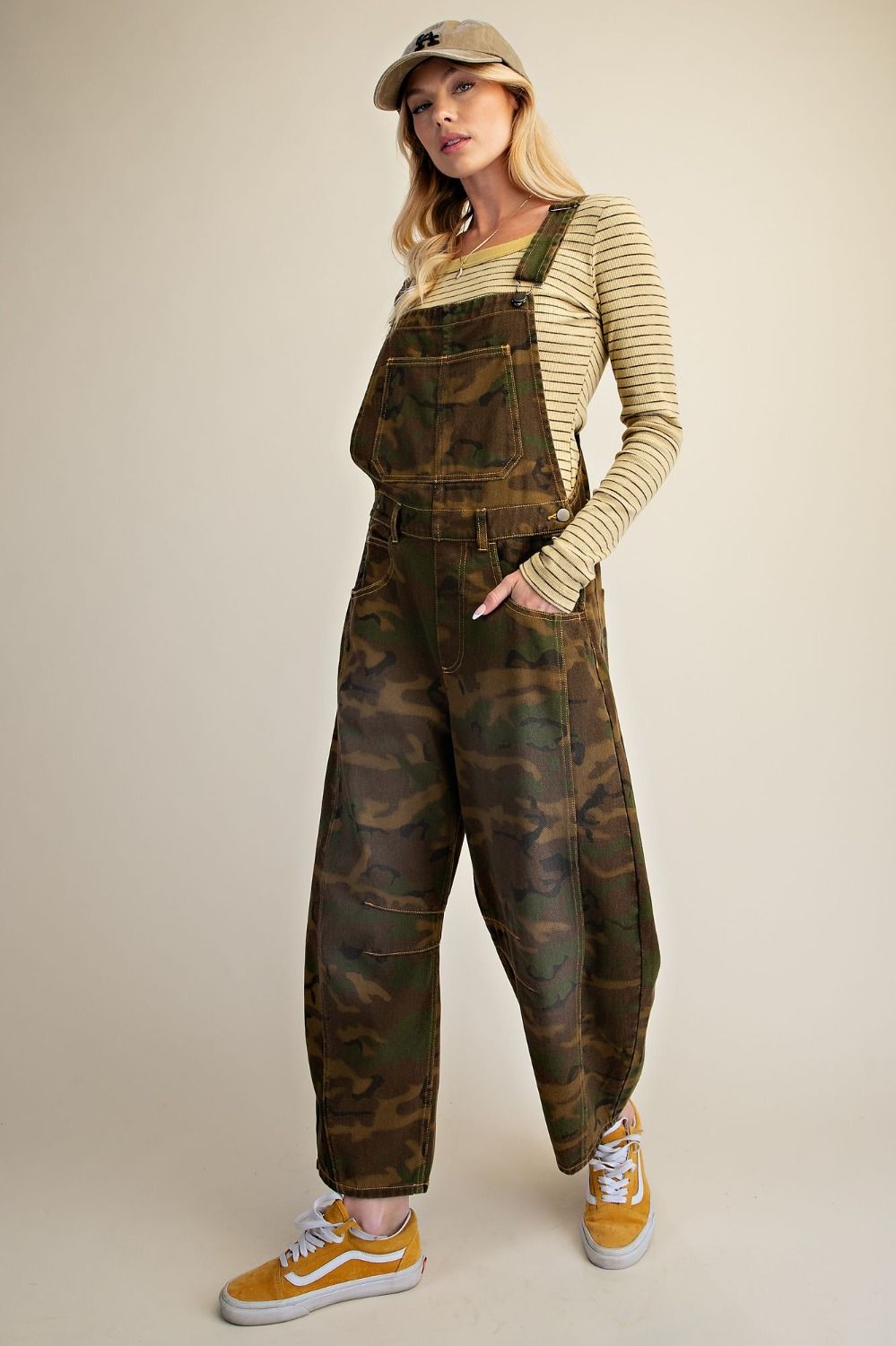 Women’s olive and brown camouflage barrel leg overalls with adjustable straps, front bib pocket and relaxed fit