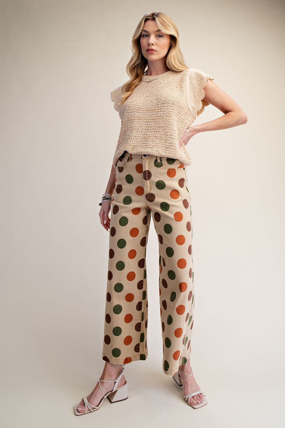 Light beige French Countryside Knit Top with flutter eyelet lace flutter sleeves, open-knit texture, relaxed fit, paired with polka dot pants