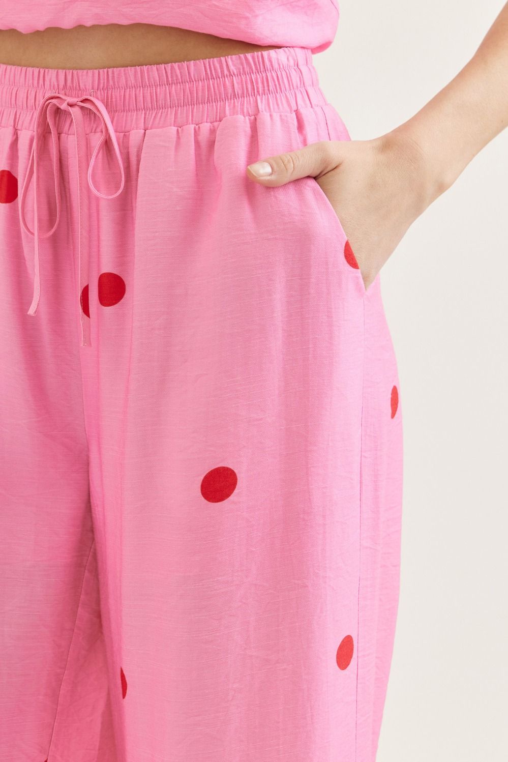 Pink polka dot lounge pants with an elastic waistband, drawstring tie, side pocket, and red polka dot pattern, casual wear for women - SKU: 12345