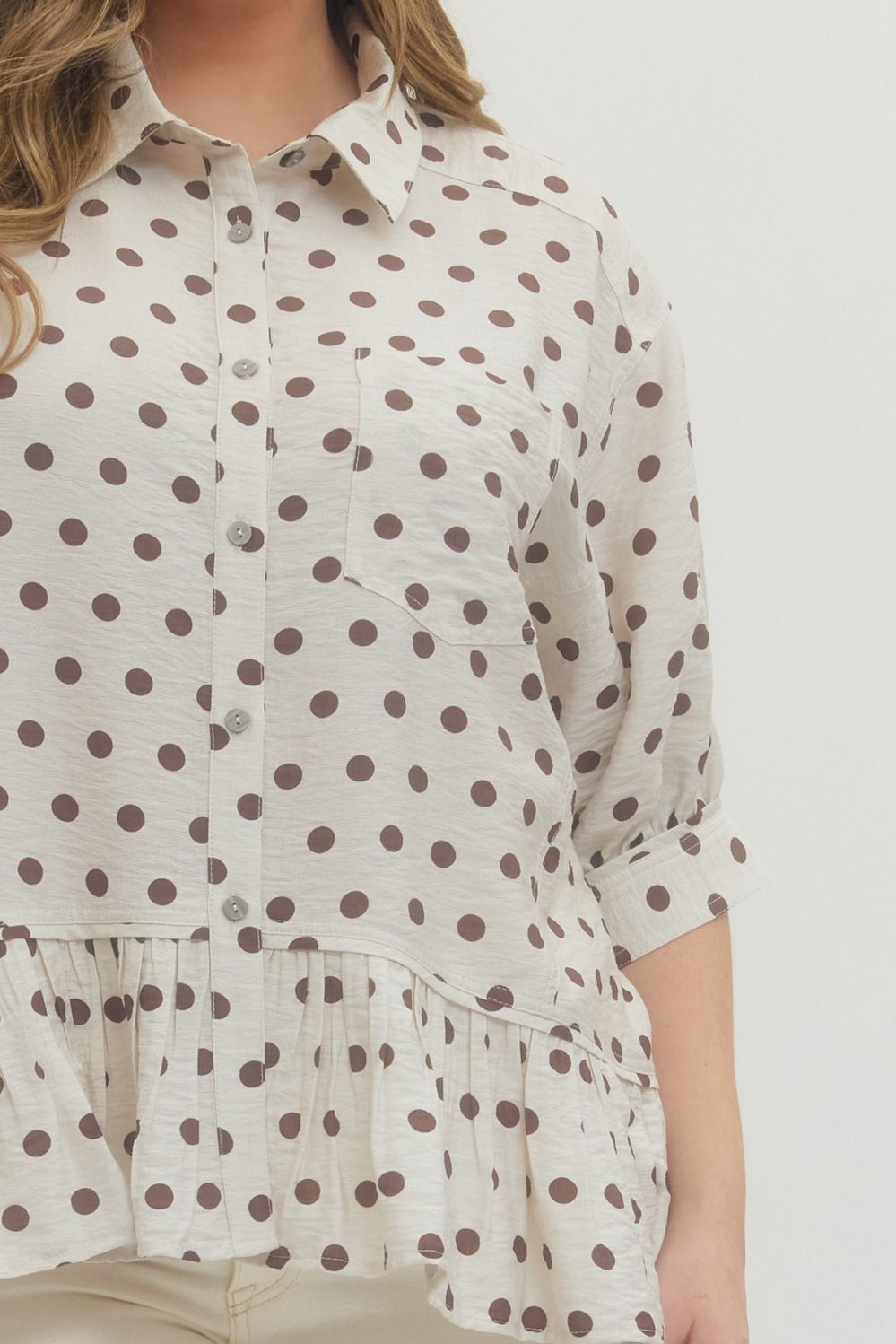 neutral polka dot top with ruffle hem and short sleeves boutique style