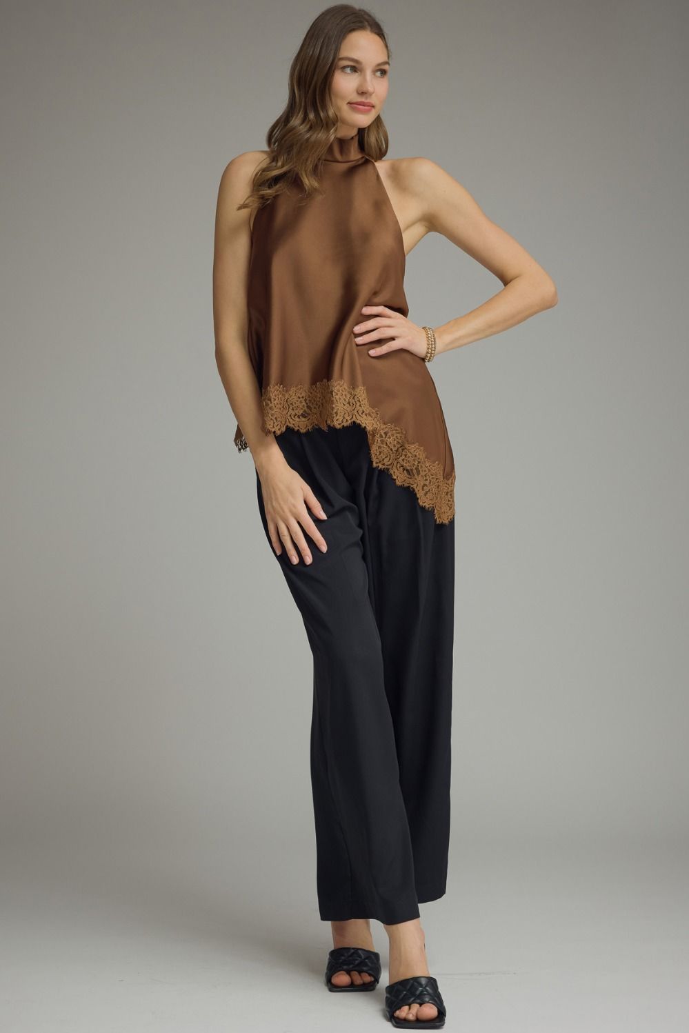 Women’s sleeveless satin top with a high neck and delicate lace trim, perfect for date nights, parties, and special occasions.