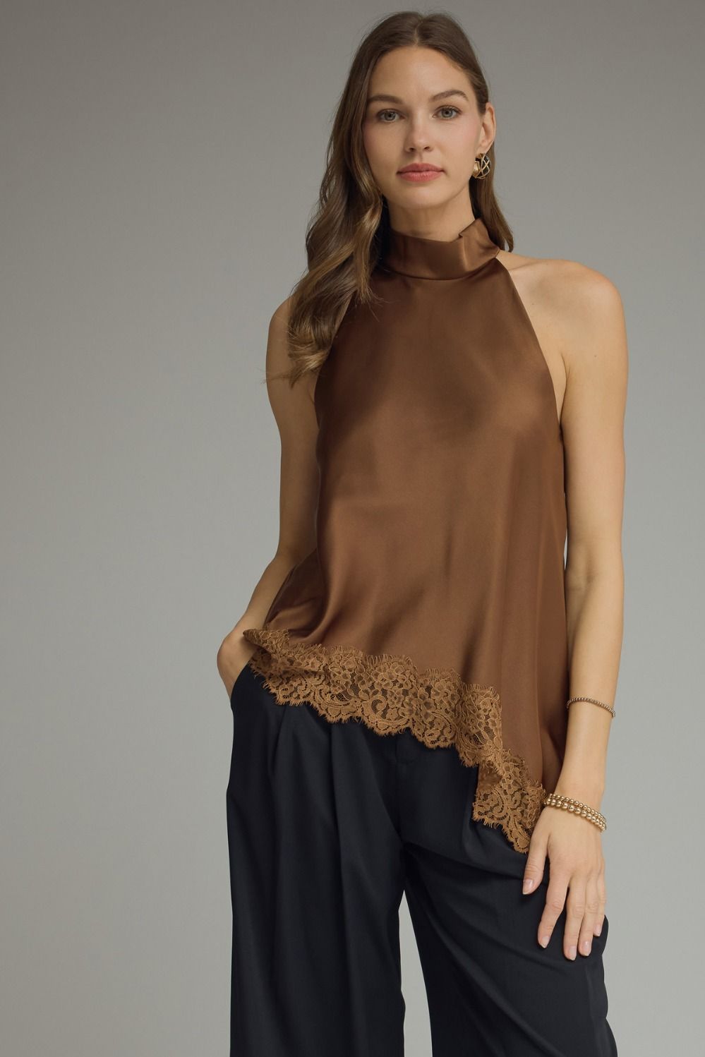 Women’s satin halter top with a high neckline, lace trim hem, and elegant sleeveless silhouette available in black, chocolate brown, and burgundy