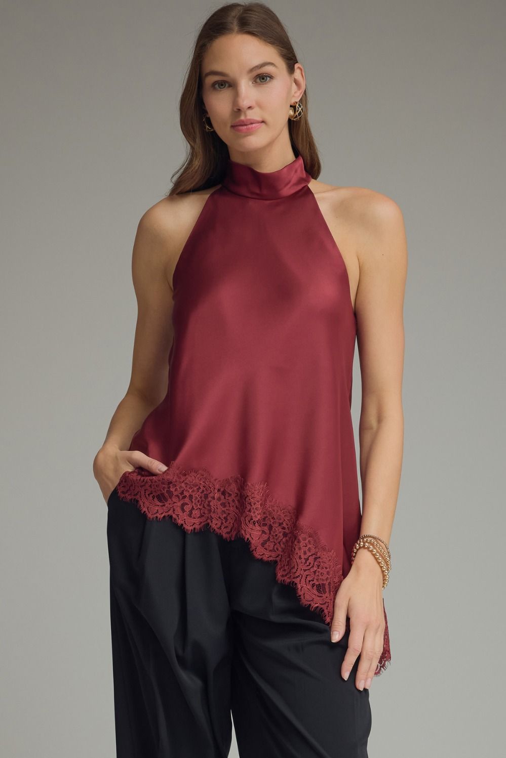 Elegant satin halter blouse for women featuring a mock neck, asymmetrical lace hem, and dressy boutique style in black, chocolate brown, and burgundy.