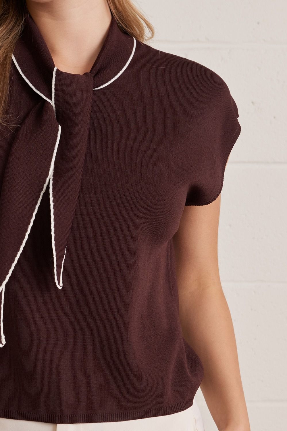 Women's lightweight sweater top styled with dress pants