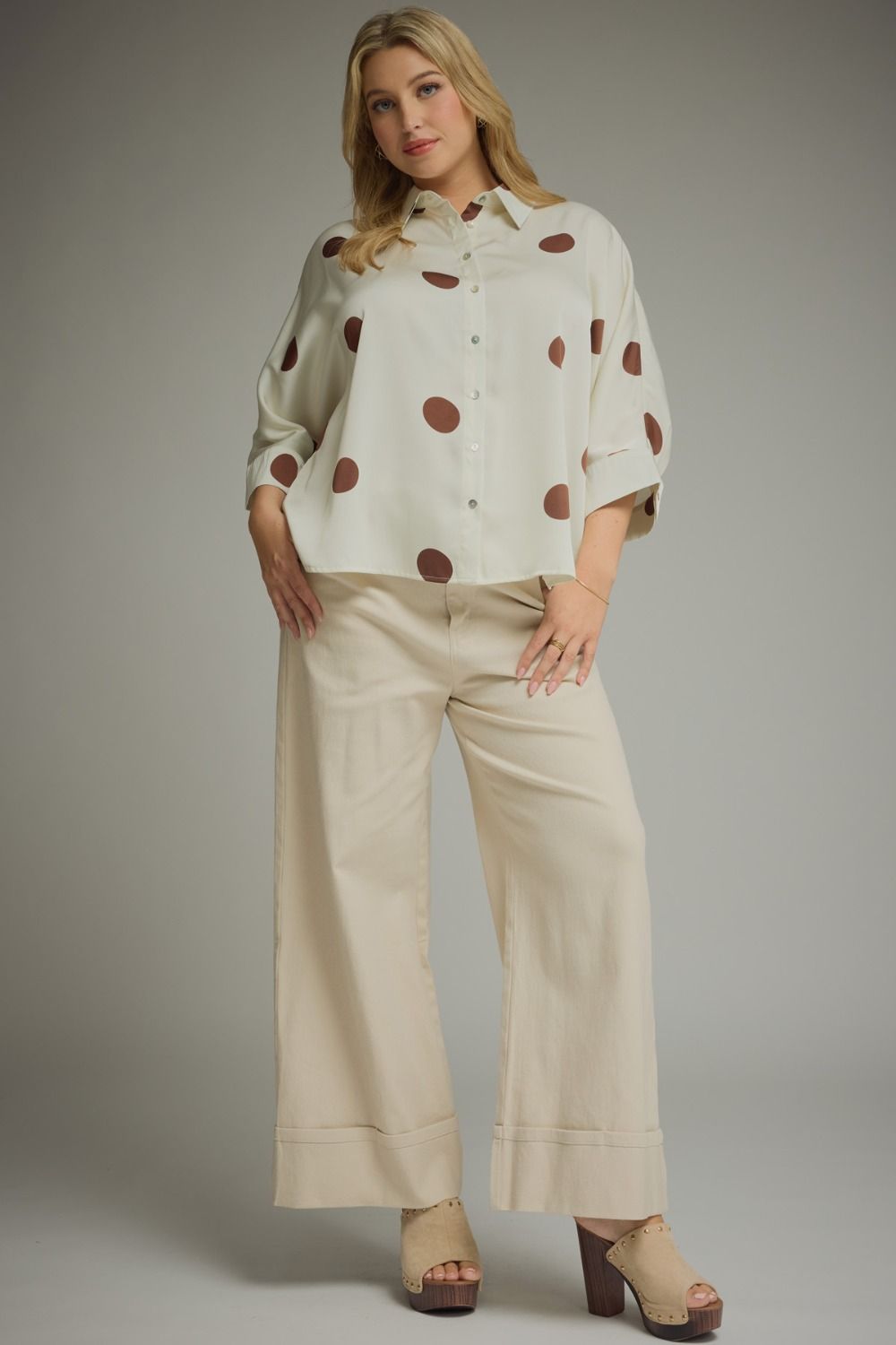 Curvy women's button-up blouse in cream with brown polka dots