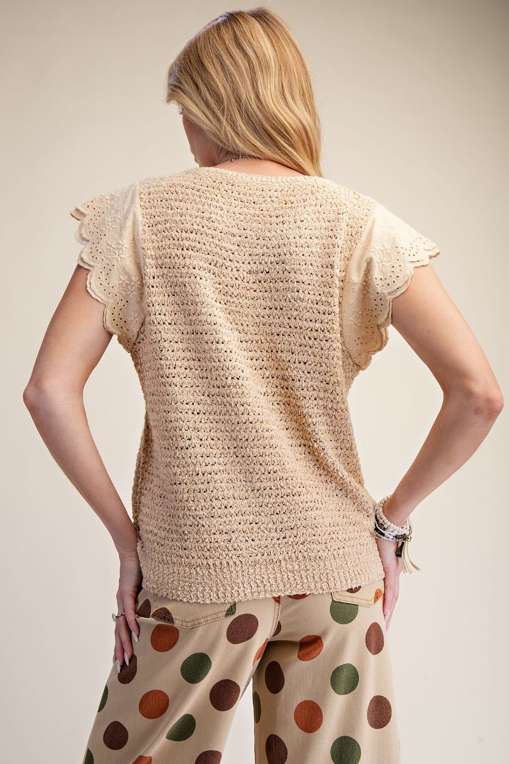 Beige knit top with delicate scalloped eyelet lace flutter sleeves and open-knit texture, relaxed fit, perfect for transitional seasons