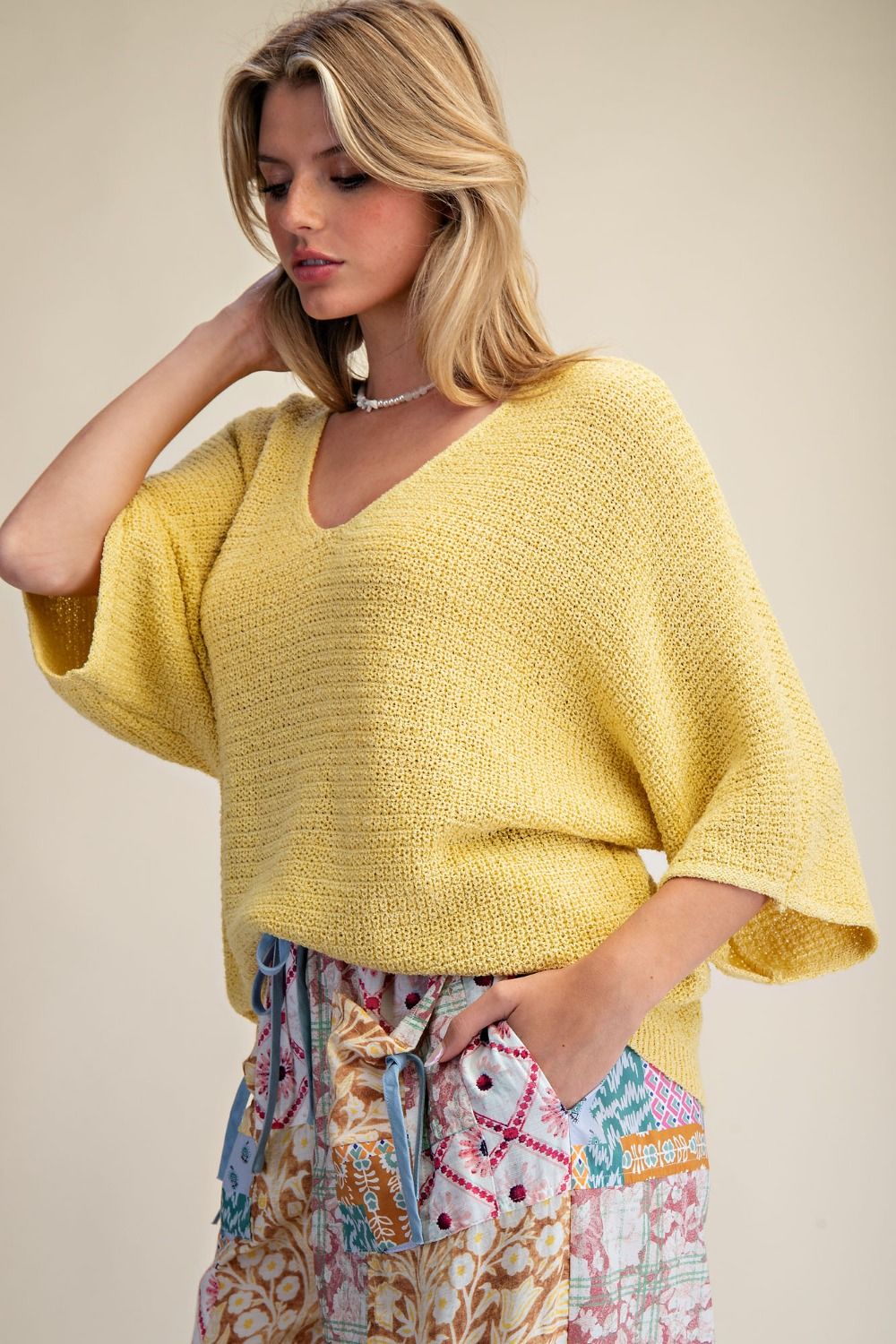 Oversized, yellow knit sweater top for women.