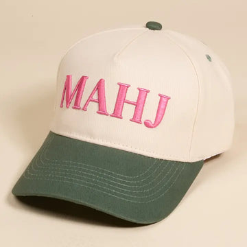 MAHJ trucker hat with green brim and pink wording 
