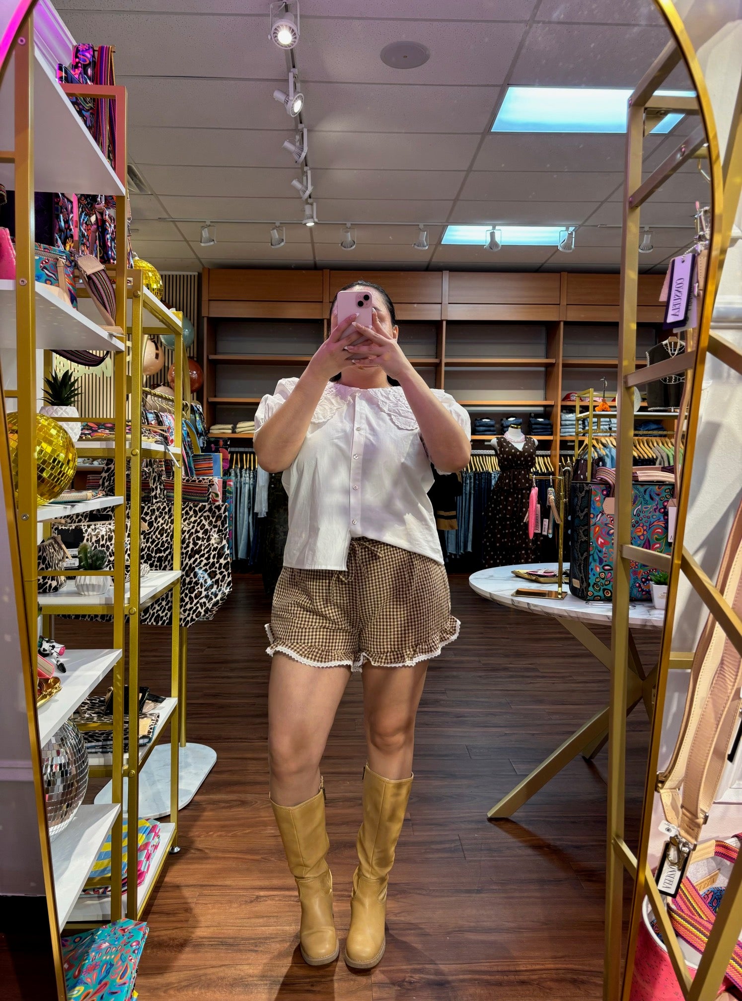 Women’s chocolate brown and cream gingham shorts featuring a ruffled hem, cream lace trim and self-tie waist detail.